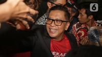 Hasto Kristiyanto terlihat memakai baju warna merah dipadu dengan jas berwarna hitam. (Liputan6.com/Helmi Fithriansyah)
