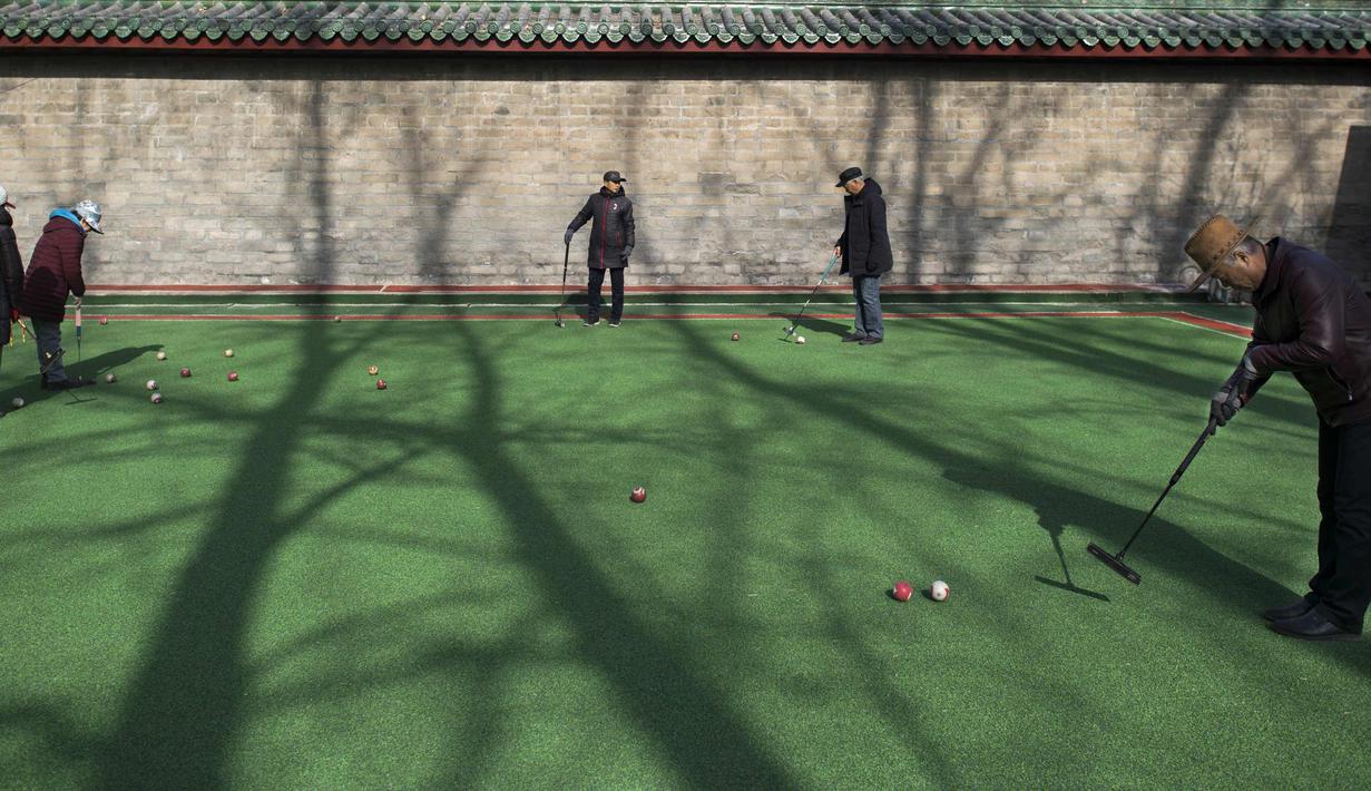 Sejumlah warga bermain kroket di Ditan Park di Beijing (1/2). Tahun Baru Imlek jatuh pada 16 Februari tahun ini, dengan perayaan yang berlangsung selama seminggu di China. (AFP Photo/Nicolas Asfouri)