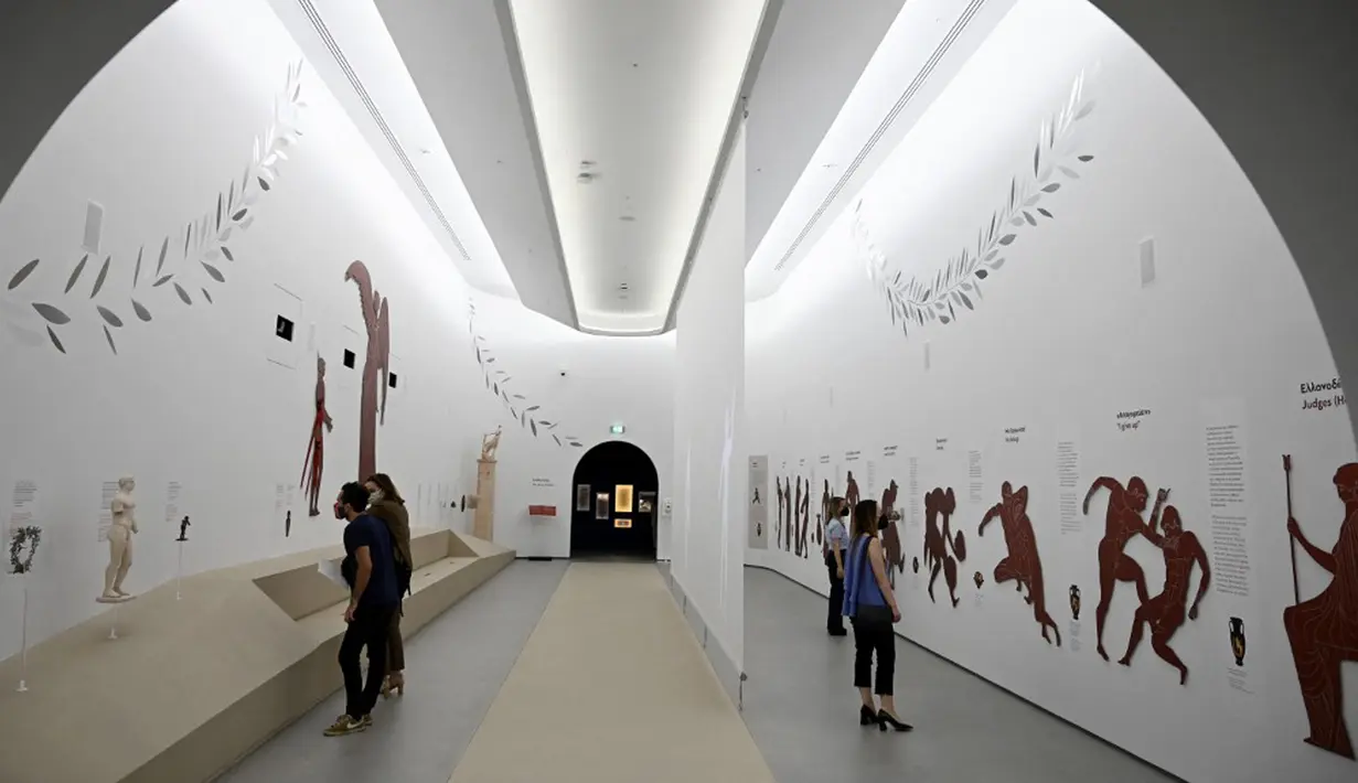 Pengunjung melihat pameran Museum Olimpiade Athena yang baru pada 25 Mei 2021. Tempat lahirnya Olimpiade modern, Athena, akhirnya memiliki museum Olimpiadenya. (Aris MESSINIS/AFP)