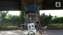 Pedagang melintasi sisi tiang penyangga Jalan Tol Pelabuhan Lingkar Dalam Jakarta di Jalan Ancol Timur, Jakarta, Selasa (16/6/2020). Seni mural yang dulu menghiasi tiang-tiang jalan tol di kawasan tersebut kini terlihat kusam dan berdebu. (Liputan6.com/Helmi Fithriansyah)