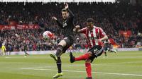 Pemain Southampton Ryan Bertrand (kanan) menghalau bola dari kejaran pemain Liverpool, Adam Lallana pada lanjutan liga Inggris pekan ke-31 di Stadion St Mary, Southampton, Minggu (20/3/2016) WIB. (AFP/Adrian Dennis)