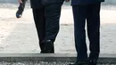 Presiden Korea Selatan, Moon Jae-in mempersilahkan Pemimpin Korea Utara, Kim Jong-un melintasi perbatasan yang ditandai dengan tembok beton pendek setinggi mata kaki di Zona Demiliterisasi (DMZ), Panmunjom, Jumat (27/4).  (Korea Summit Press Pool via AP)