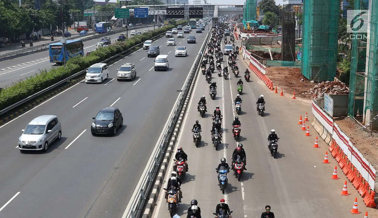 Konvoi buruh menggunakan sepeda motor melintas di Jalan Gatot Soebroto, Jakarta, Selasa (1/5). Ribuan buruh dari berbagai elemen memperingati perayaan Hari Buruh untuk menyampaikan aspirasi di sejumlah titik di Ibukota. (Liputan6.com/Immanuel Antonius)