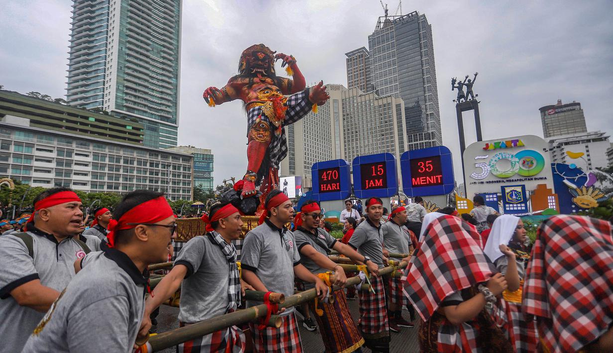 Ini merupakan bagian dari acara menyambut Hari Raya Nyepi 1948 Saka. Tampak dalam foto, warga mengarak ogoh-ogoh saat pawai budaya di kawasan Bundaran Hotel Indonesia, Jakarta, Minggu (8/3/2026). (merdeka.com/Arie Basuki)