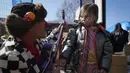 Seorang gadis Ukraina dihibur oleh Javier Way Waka Katz, badut dari organisasi Dream Doctors dari Israel, di perbatasan Medyka, Polandia, 24 Maret 2022. Para badut medis beraksi di perbatasan antara Ukraina dan Polandia untuk menghibur anak-anak pengungsi dan orang tuanya. (AP Photo/Sergei Grits)