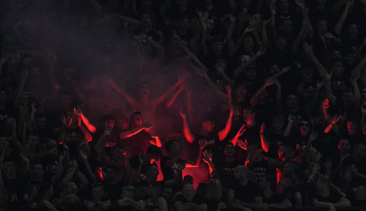 Para suporter AC Milan menyalakan flare saat memberi dukungan kepada timnya saat menghadapi Newcastle United pada laga matchday pertama Grup F Liga Champions 2023/2024 menghadapi AC Milan di San Siro Stadium, Milan, Rabu (20/9/2023) dini hari WIB. (AP Photo/Antonio Calanni)