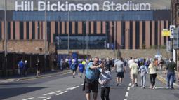 Seorang anak dan ayahnya melakukan swafoto dengan latar belakang Stadion Hill Dickinson menjelang laga Liga Inggris antara Everton melawan Brighton pada Minggu (24/08/2025) waktu setempat. (AP Photo/Jon Super)