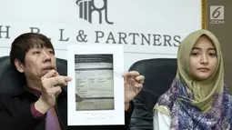 Pengacara Henry Indraguna menunjukkan bukti pembayaran yang dilakukan Arafah Rianti saat jumpa pres terkait dugaan penipuan yang dialami Arafah, Jakarta, Kamis (6/7). (Liputan6.com/Helmi Afandi)