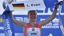 Pelari Top asal Jerman, Katharina Heinig merayakan keberhasilannya memasuki finish pada urutan kelima ajang Berlin Maraton di Berlin (25/9/2016). AFP/John Macdougall)