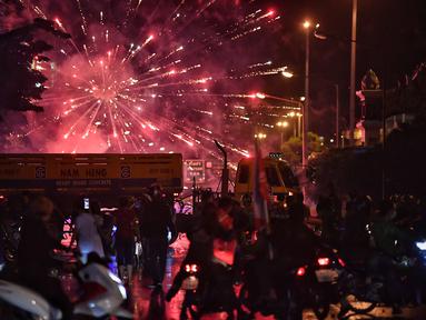 Pengunjuk rasa anti-pemerintah meluncurkan petasan ke arah polisi selama demonstrasi di Bangkok, Thailand, Minggu (6/9/2021). Aksi unjuk rasa yang menyuarakan pengunduran diri Perdana Menteri Thailand, Prayut Chan-O-Cha makin mencekam hingga malam hari. (AFP/Jack Taylor)
