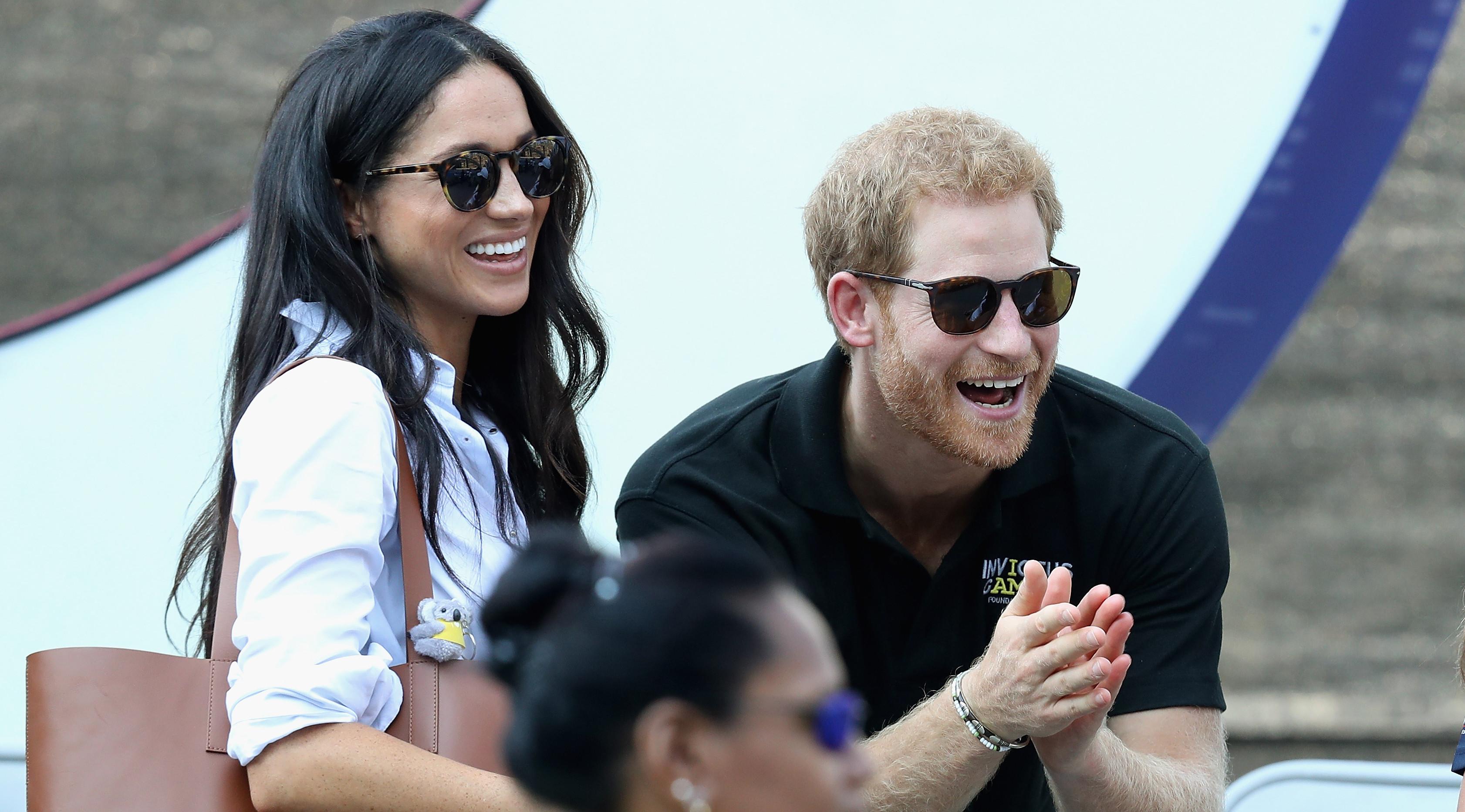 Putra kerajaan Inggris, Pangeran Harry dan aktris Meghan Markle menonton pertandingan tenis kursi roda selama Invictus Games 2017 di Toronto, Kanada, Senin (25/9). Ini merupakan penampilan publik pertama mereka bersama. (Chris Jackson/GETTY IMAGES/AFP)