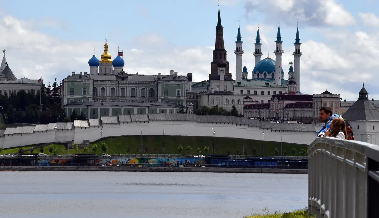 Sepasang turis mengamati sungai Kazanka dengan latar belakang masjid Kul-Sharif di Kazan, Rusia, 9 Juni 2018. Masjid ini juga menyandang predikat sebagai salah satu masjid terbesar di Rusia dan wilayah Eropa timur. (AFP PHOTO/SAEED KHAN)
