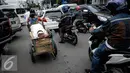 Tatapan seorang bocah yang dibawa ibunya dengan gerobak melintasi jalan Wahid Hasyim, Jakarta untuk mencari barang bekas, Kamis (6/10). Penduduk miskin Jakarta meningkat menjadi 384.300 orang atau 3,75% dari total penduduk. (Liputan6.com/Faizal Fanani)