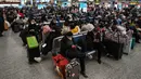 Calon penumpang menunggu kereta di Stasiun Hongqiao, Shanghai China, 11 Januari 2023. Migrasi tahunan di China dimulai dengan orang-orang kembali ke kampung halaman mereka untuk merayakan Tahun Baru Imlek. (Hector RETAMAL/AFP)