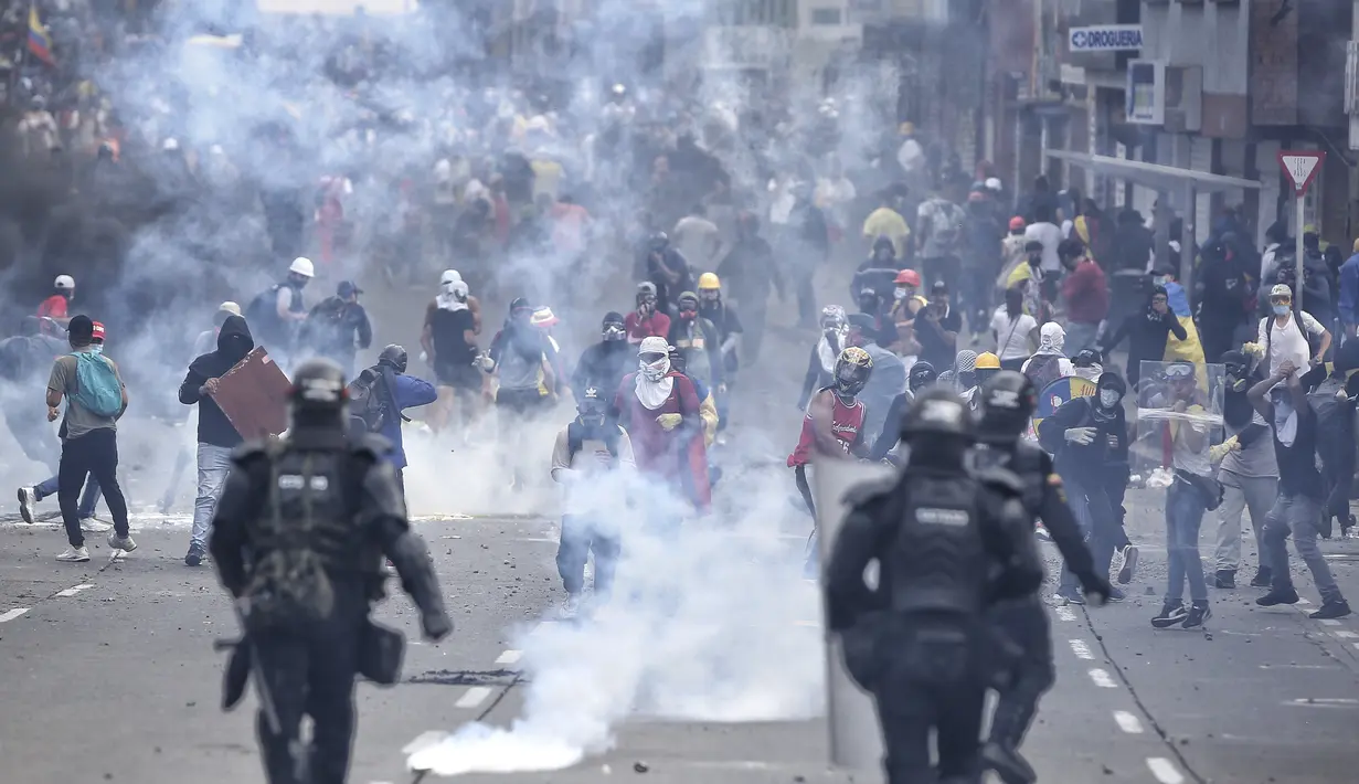 Demonstran bentrok dengan polisi selama protes anti-pemerintah di tengah perayaan Hari Kemerdekaan Kolombia, di Cali, Selasa (20/7/2021). Warga Kolombia kembali turun ke jalan ketika pemerintah secara resmi mengajukan RUU reformasi pajak $3,95 miliar kepada Kongres. (AP Photo/Andres Gonzalez)