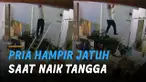 Hampir saja jatuh dari tangga. Pria ini masih bisa bergelantungan di bagian atas gedung.