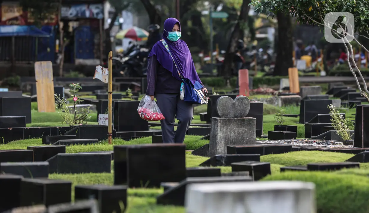 Warga berziarah di makam keluarganya di Tempat Pemakaman Umum (TPU) Tanah Kusir, Jakarta, Selasa (29/3/2022). TPU setempat semakin banyak dikunjungi warga yang melakukan tradisi ziarah kubur menjelang Ramadhan. (Liputan6.com/Johan Tallo)