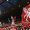 Para suporter Liverpool merayakan kemenangan atas Manchester United pada laga Premier League di Stadion Anfield, Liverpool, Minggu (16/12). Liverpool menang 3-1 atas MU. (AFP/Paul Ellis)