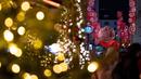 Orang-orang berjalan di sebuah jalan yang dihiasi dengan lampu-lampu Natal di pusat kota Wina, Austria pada 19 November 2024. (JOE KLAMAR/AFP)