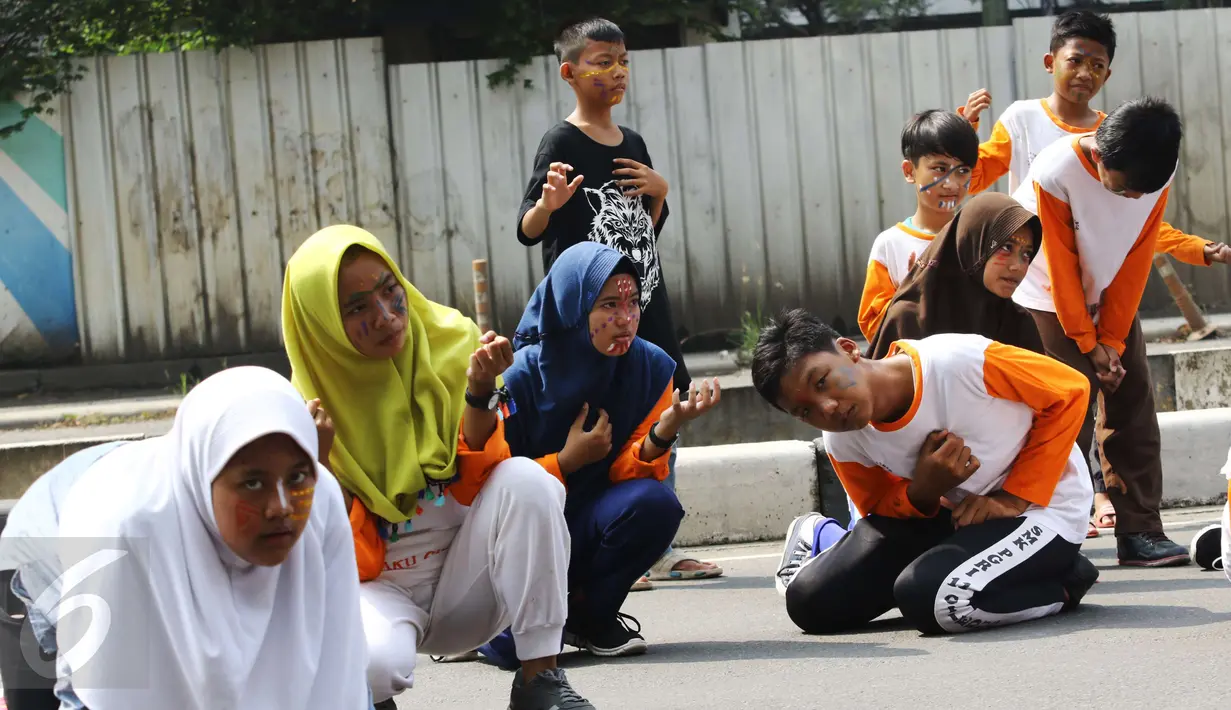 Penampilan teater anak-anak dari Rumah Amalia yang digelar di Car Free Day, Jakarta, Minggu (5/3). Aksi pementasan teater dengan tema "Kangen Ayah" ini diselenggarakan sebagai bentuk penggambaran anak yang kehilangan ayah. (Liputan6.com/Helmi Afandi)