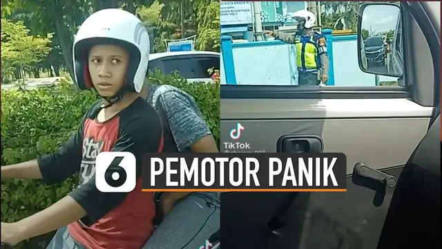 Pengemudi yang berhelm nampak ketakutan bila terjaring petugas.