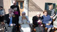 Paus Emeritus Benediktus XVI meminum segelas bir bersama Perdana Menteri Bavaria Horst Seehofer saat merayakan ulang tahunnya yang ke-90 di Vatikan (17/4). (L'Osservatore Romano/Pool Photo via AP)