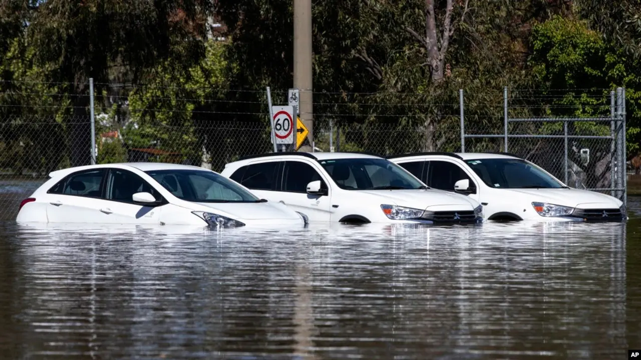 Tiga mobil terjebak dalam banjir di Shepparton, Australia, Senin, 17 Oktober 2022. Sekitar 34.000 rumah dapat terendam atau terisolasi di negara bagian Victoria saat keadaan darurat banjir berlanjut di bagian tenggara Australia. (Diego Fedele/AAP via AP)