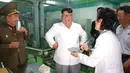 Tawa Pemimpin Korea Utara Kim Jong-un (tengah) saat mengunjungi Pabrik No. 525 di Korea Utara, Rabu (25/7). Pabrik No. 525 memproduksi makanan khusus atau ransum untuk tentara Korea Utara. (STRINGER/AFP/KCNA VIA KNS)