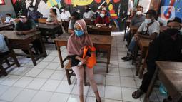 Warga antre untuk mengambil uang Bantuan Sosial Tunai (BST) di SDN Pondok Cabe Udik 03, Tangerang Selatan, Rabu (28/07/2021). Lebih dari dari 1800 warga mendapatkan BST yang dirapel dua bulan sekaligus dengan total Rp600ribu. (merdeka.com/Arie Basuki)