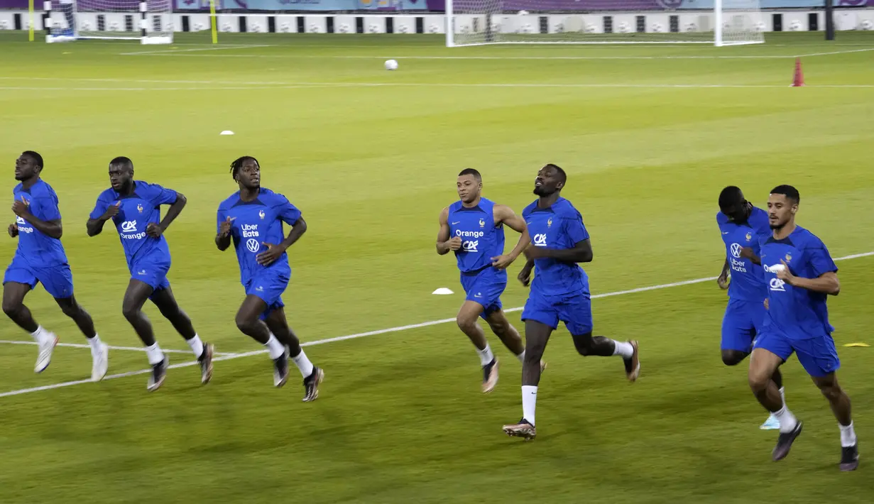 Para pemain tim Prancis melakukan pemanasan selama sesi latihan di stadion Jassim Bin Hamad di Doha, Qatar, Kamis, 24 November 2022. Prancis akan bermain di Piala Dunia melawan Denmark pada 26 November. (AP Photo/Christophe Ena)