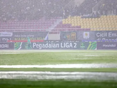 Air hujan menggenangi lapangan pertandingan dalam laga final Pegadaian Liga 2 2024/2025 antara Bhayangkara FC melawan PSIM Yogyakarta di Stadion Manahan, Solo, Jawa Tengah, Rabu (26/02/2025). (Bola.com/Abdul Aziz)