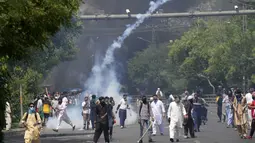 Penangkapan Khan terjadi saat dirinya menghadiri persidangan di pengadilan tinggi Islamabad. Memicu bentrokan antara pendukungnya dan polisi. (AP Photo)