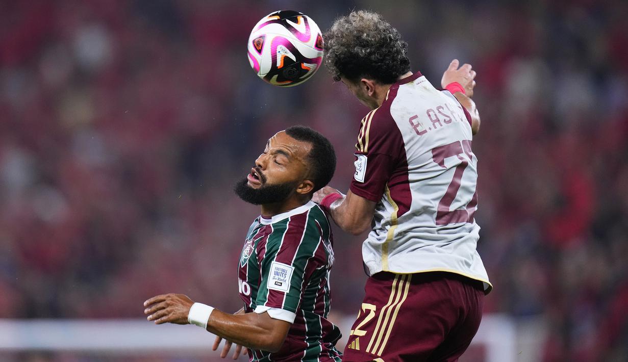 Gelandang Al Ahly, Emam Ashour (kanan) memenangi duel udara dengan bek Fluminense, Samuel Xavier pada laga semifinal Piala Dunia Klub 2023 di King Abdullah Sports City Stadium, Arab Saudi, Selasa (19/12/2023) dini hari WIB. (AP Photo/Manu Fernandez)