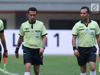 Wasit asal Iran, Bonyadifard Mooud (tengah) berjalan bersama asistennya, Alinezhadian Saeid dan Mirzabeigi Ali usai memimpin laga Persija melawan PSM Makassar di Stadion Patriot Candrabhaga, Bekasi, Selasa (15/8). (Liputan6.com/Helmi Fithriansyah)
