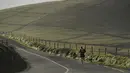 Seorang pria berlari dengan anjingnya di Slea Head, Ventry, Irlandia, Selasa (27/12). Irlandia mendapat julukan Pulau Zamrud karena memiliki pemandangan alam yang hijau terang. (REUTERS / Clodagh Kilcoyne)