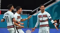 Striker Portugal, Cristiano Ronaldo merayakan golnya ke gawang Hungaria dalam laga perdana Grup F Euro 2020, Selasa (15/6/2021). (Attila KISBENEDEK / POOL / AFP)