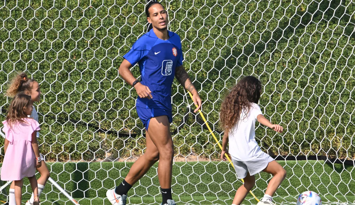 <p>Bek Timnas Belanda Virgil van Dijk bermain dengan putrinya saat pertemuan dengan kerabat usai sesi latihan di tempat latihan Universitas Qatar, Doha, Qatar, Selasa (22/11/2022). Ajang Piala Dunia tahun ini menjadi turnamen dunia perdana pemain dengan nomor punggung 4 tersebut. (Alberto PIZZOLI/AFP)</p>