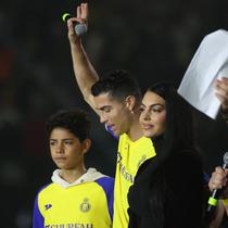 Cristiano Ronaldo bersama sang kekasih Georgina Rodriguez dan putranya Cristiano Ronaldo Jr naik panggung saat upacara penyambutan dirinya sebagai pemain baru Al Nassr di Stadion Mrsool Park, di ibu kota Saudi, Riyadh, Selasa (3/1/2023). (Fayez Nureldine / AFP)