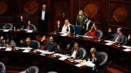 Senator Uruguay, Michelle Suarez (tengah baris belakang ) memberikan suara saat sesi Senat, di Montevideo, Uruguay (10/10). Sebagai senator, Suarez bertugas merancang undang-undang pernikahan sejenis. (AP Photo / Matilde Campodonico)