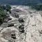 Sejumlah rumah tampak terendam berlumpur di tepi sungai setelah banjir bandang melanda Trishuli Bazar di distrik Nuwakot, Nepal, Rabu, 26 Agustus 2026. (AFP/ Prabin Ranabhat)