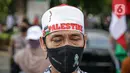 Massa Gerakan Pekerja Muslim Indonesia (GPMI) melakukan aksi solidaritas untuk Palestina di kawasan Thamrin, Jakarta, Jumat (28/5/2021). Massa yang datang terlihat menggunakan atribut Palestina seperti bendera besar dan syal. (Liputan6.com/Faizal Fanani)