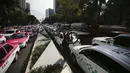 Sopir taksi memblokir bundaran monumen Angel of Independence di Jalan Paseo de la Reforma, Mexico City, Meksiko, Senin (12/10/2020). Para sopir taksi menuntut kondisi yang sama dengan layanan transportasi online, seperti peraturan dan biaya pemerintah. (AP Photo/Fernando Llano)