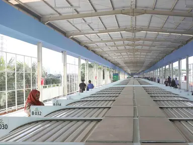Pejalan kaki melintasi jembatan penyeberangan multiguna (JPM) atau Skybridge Tanah Abang, Jakarta, Jumat (7/12). Skybridge Tanah Abang mulai diuji coba hari ini. (Liputan6.com/Immanuel Antonius)