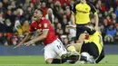 Pemain Manchester United, Anthony Martial (kiri) terjatuh saat berebut bola dengan pemain, Burton Albion, Tom Naylor pada laga Piala Liga Inggris di Old Trafford, Manchester (20/9/2017). MU menang 4-1. (Martin Rickett/PA via AP)