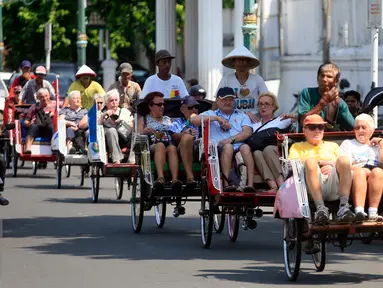 Wisatawan mancanegara menaiki becak saat mengelilingi kawasan alun alun Kraton Kesultanan Yogyakarta, Rabu (4/5). Becak menjadi transportasi ramah lingkungan yang di minati wisatawan karena tidak menimbulkan polusi udara. (Liputan6.com/Boy Harjanto)