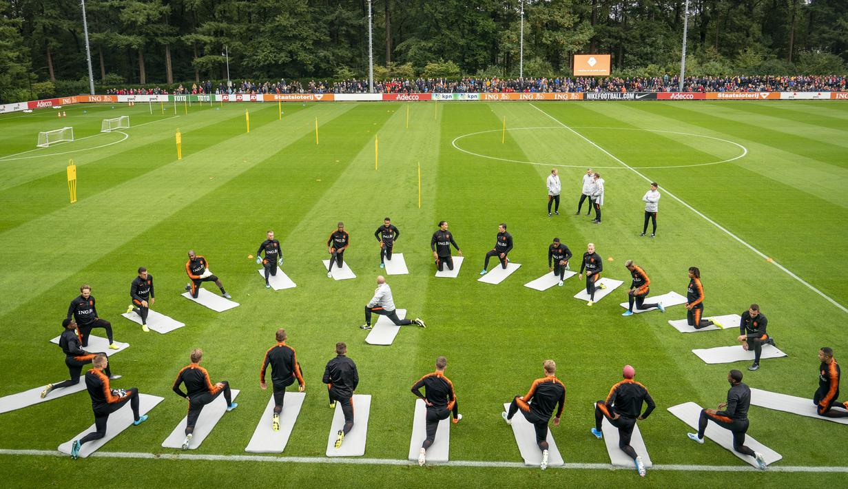 Pemain Belanda melakukan pemanasan saat mengikuti latihan di Zeist (9/10/2019). Timnas Belanda akan bertanding melawan Irlandia Utara pada grup C kualifikasi Euro 2020 di Stadion Feijenoord. (Jerry Lampen/ANP/AFP)