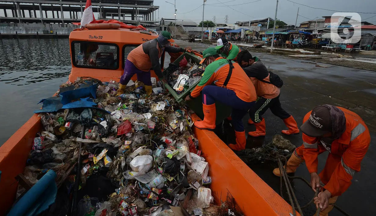 Petugas dari Dinas Lingkungan Hidup DKI Jakarta mengangkut sampah di Pelabuhan Kali Adem, Muara Angke, Jakarta, Rabu (6/1/2021). Dalam sehari, sampah pesisir Teluk Jakarta Utara bisa terangkut sekitar 7 kubik sampah plastik yang terbawa dari sungai maupun arus laut. (merdeka.com/Imam Buhori)