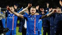 Kapten timnas Islandia, Aron Gunnarsson merayakan kemenangan timnya atas Kosovo pada laga Grup I Kualifikasi Piala Dunia 2018 di Laugardalsvollur, Senin (9/10). Menang 2-0, Islandia pertama kalinya tampil dalam gelaran Piala Dunia. (AP/Brynjar Gunnarsson)