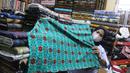 Pekerja menyusun bahan kain di Pasar Tanah Abang, Jakarta, Sabtu (27/11/2021). Utilisasi industri tekstil dan produk tekstil dalam negeri menunjukkan kinerja yang positif menjelang akhir 2021. Utilisasi industri itu berada di posisi 80 - 85 persen pada awal kuartal IV/2021. (Liputan6.com/Angga Yunia