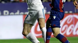 Pemain Real Madrid Gareth Bale berusaha melewati pemain Levante Sergio Postigo saat pertandingan Liga Spanyol di stadion Ciutat de Valencia di Valencia (3/2). (AP Photo/Alberto Saiz)